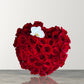 Skye Rose Floral heart-shaped box filled with deep red roses and a single white orchid for a romantic gift.