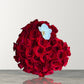 Skye Rose Floral heart-shaped box filled with deep red roses and a single white orchid for a romantic gift.