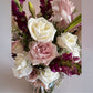 Skye Rose Floral Sophisticated Mauve bouquet with cream and dusty mauve roses and burgundy snapdragons in a vase.