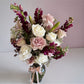 Skye Rose Floral Sophisticated Mauve bouquet with cream and dusty mauve roses and burgundy snapdragons in a glass vase.