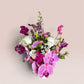 Skye Rose Floral Plum Essence arrangement with pink Phalaenopsis orchids, calla lilies, and white roses in a white vase.